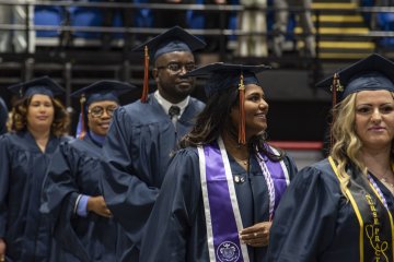 Members of the Graduate Class of 2026 in blue gowns and caps.