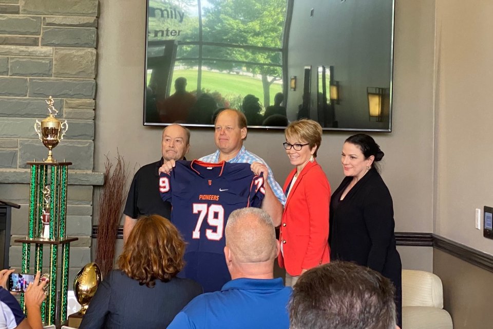 Floyd Fire Chief John Stark receives a jersey as an honorary Pioneer Captain.