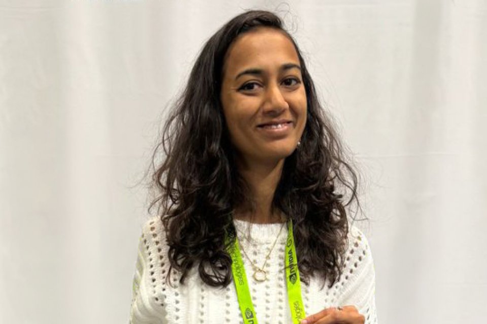 Dr. Rutal Mahajan stands in front of a white curtain
