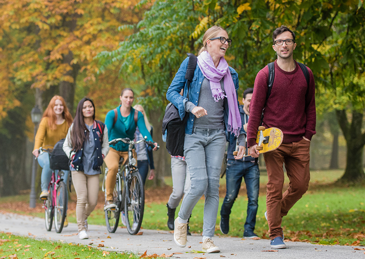 students walking path outside Utica grounds