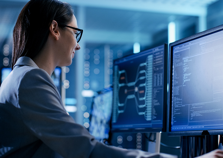 cybersecurity professional reviewing code at desk